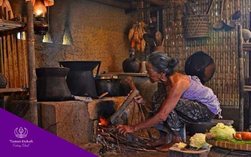 Interior of a traditional Balinese kitchen (Paon), the sacred heart of a Balinese home, showing its unique structure and connection to Dewa Brahma.